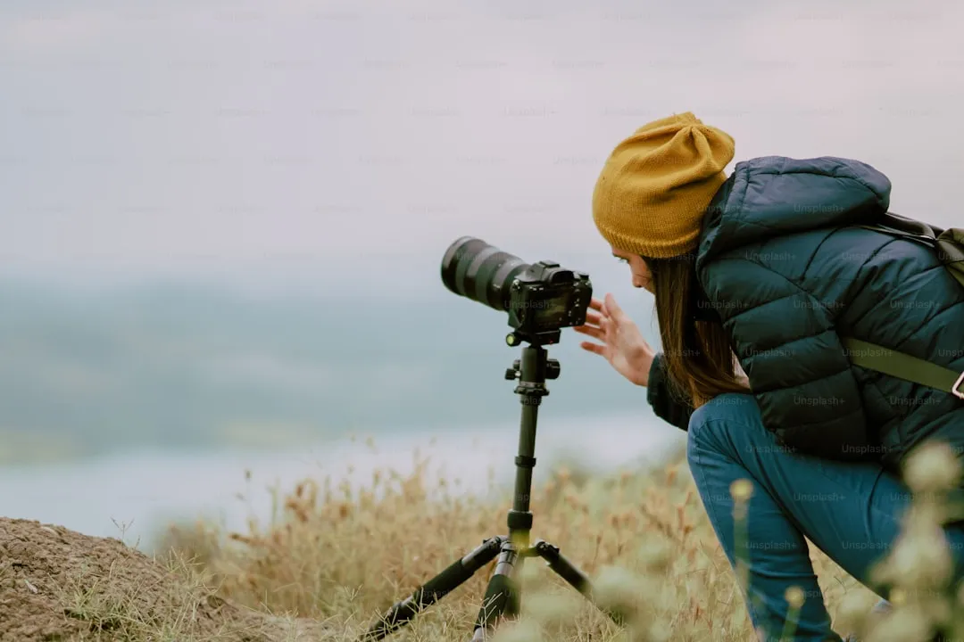 young woman shooting with camera at morning.Tripod and mirrorless camera.