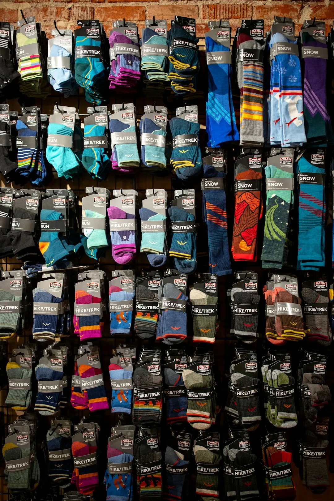 Wall display of colorful socks with various patterns.
