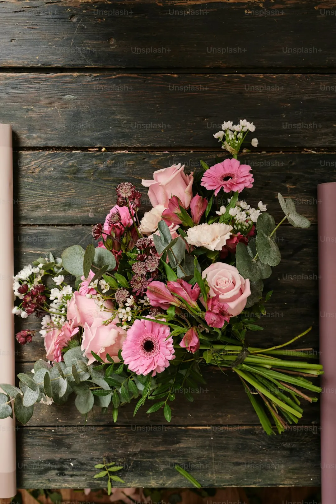a bouquet of flowers sitting on top of a wooden table